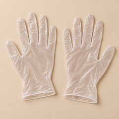 Clear vinyl disposable gloves — representative unbranded mockup on beige; size shown in listing