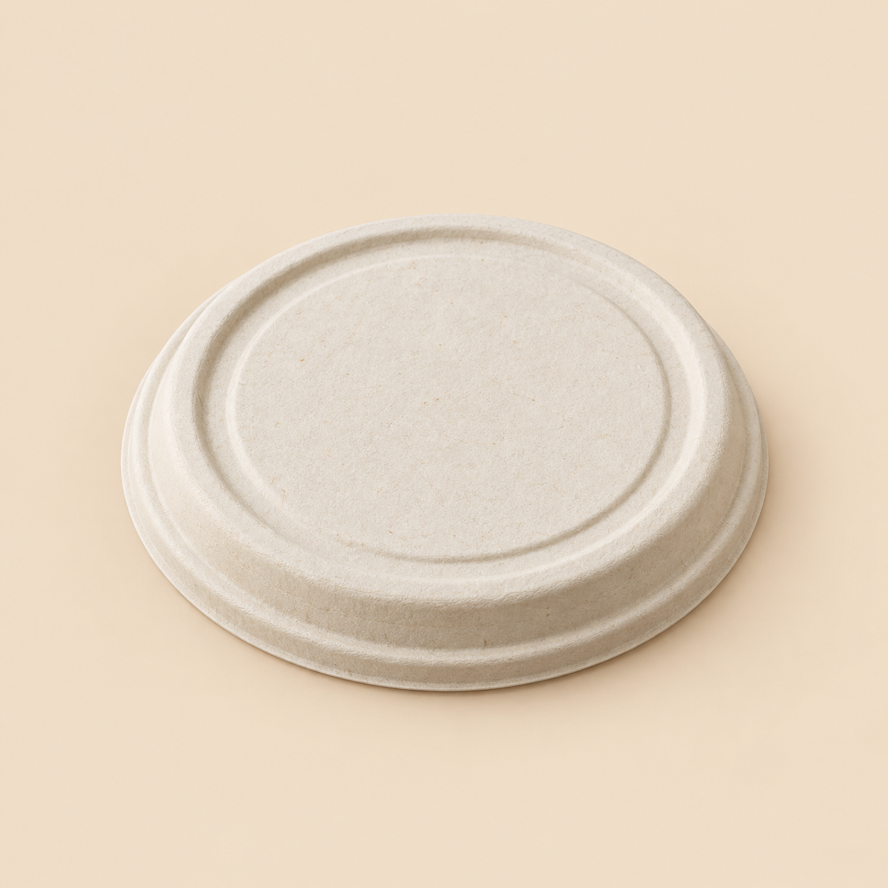 Illustrative mockup: one separate unbranded round biodegradable molded-fiber lid for a 24 to 32 fluid ounce food-service bowl, natural off-white bagasse texture, flat circular top with a raised rim fitting over a bowl; show lid only with no bowl