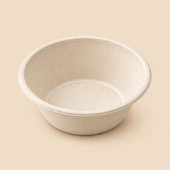 Illustrative product mockup: one empty unbranded 32-fluid-ounce disposable biodegradable molded-fiber round bowl, natural off-white bagasse texture, deep food-service bowl with flared sides and circular rim; no lid